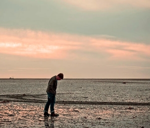 Lone Man on Beach at Sunset