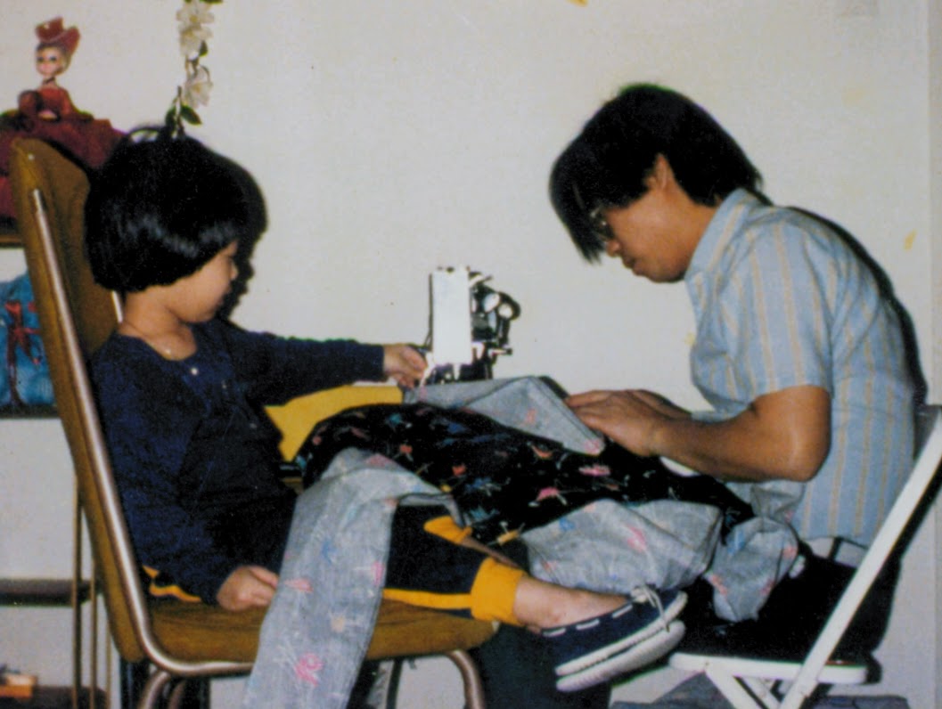 My father sewing, helping my mother